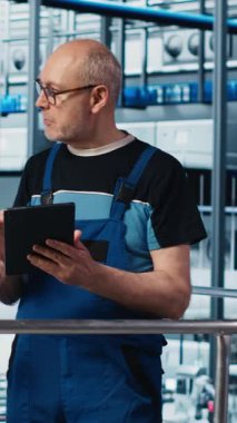 Dikey video Photovoltaics akıllı fabrika kalite kontrol subayı sistem tasarımı ve güvenilirliğini denetliyor. Sanayi 4.0 güneş paneli üretim tesisi müfettişi çalışanlara geri bildirim sağlıyor