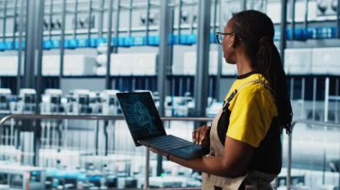 Akıllı fotovoltaik fabrikası uzmanı yapay zeka teknolojisiyle sistem performans ölçümleri topluyor. Güneş panelleri yapay zeka IoT sensörleri ve kamera A aracılığıyla enerji üretimini takip eden fabrika işçisi.