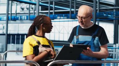 Endüstri 4.0 güneş panelleri mühendislerinin çalışma süresinin azaltılması için yaptıkları çalışmaları denetleyen kişi. Fotovoltaik zeki fabrika yöneticisi işçilere hasar gören IOT sensörlerini, kamera A 'yı tamir etme görevi veriyor.