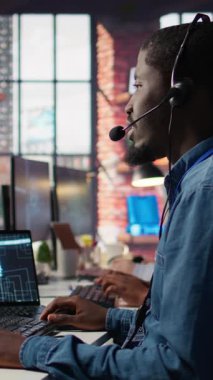 Müşteri sorularını cevaplamak için yapay zeka chatbot kullanan dikey video çağrı merkezi çalışanı. Müşteri hizmetleri suni zeka kullanarak otomatik tepkiler üreten bir adam.