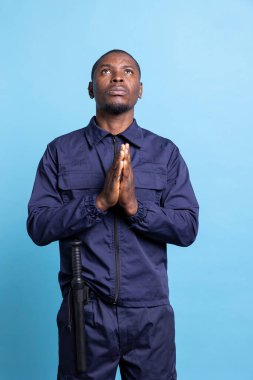 Afrikalı Amerikalı gardiyanlar İsa 'yla konuşmak için dua ederken el ele tutuşuyorlar. Hristiyanlığa ve dine inanıyorlar. Nöbetçi devriye ajanı Tanrı 'ya dua ediyor, O' na güveniyordu..