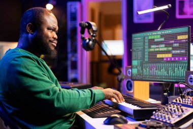 Sanatçı, kendi stüdyosundaki elektronik klavyeyle piyano notaları çalarak yeni şarkılar kaydediyor ve müzik setleri ile ana melodileri karıştırıyor. Afrikalı Amerikalı müzisyen.