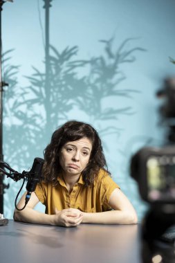 Kadın somurtuyor, üzgün hissediyor, canlı yayında üzücü bir hikaye paylaşıyor, izleyicilerle konuşuyor. Sinirli medya yıldızı izleyicilerle konuşuyor, abonelerle tartışıyor ve atıp tutuyor.