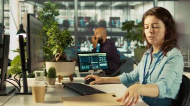 Ofis masasında oturan bir kadının mesai sırasında görevleri çözmesine yakın çekim. Ofis görevlisi işyerinde e-posta iletişimi yapıyor, şirket projesi için verileri araştırıyor, kamera B