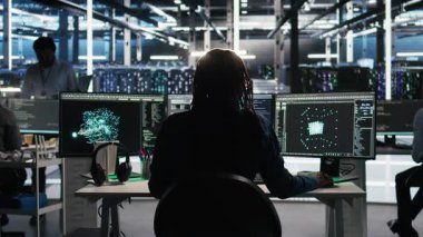 Veri merkezi mühendisi sunucu kümelerini optimize etmek için yapay zeka sanal çerçeve uygular. Sunucu merkezi Bilgi İşlem Uzmanı Yapay Zeka tahmin analizi yapıyor, Kamera A