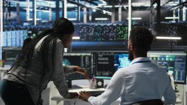 Donanım yapılandırmak için yapay zeka ağı modelleri kullanan veri merkezi mühendisi yöneticisi. Ekip lideri, sistem ve kamera A 'yı optimize etmek için makine öğrenme programlama dilini kullanan çalışanı denetliyor.