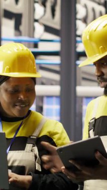 Dikey video güneş panelleri fabrika mühendisliği ekibi vites arızalarını tahmin etmek için dizüstü bilgisayardaki performans verilerini analiz eder. Takım çalışması fotovoltaik, bakım prosedürlerini takip eden meslektaşları, kamera B