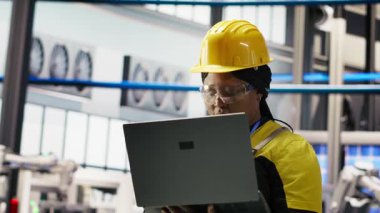 Güneş panelleri üretim hattını denetleyen teknisyen, ekipman performansını analiz eden, otomatikman çevre dostu fabrikada fotovoltaik montaj sistemlerini koruyan, kamera B