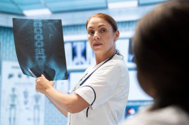 Tıbbi uzmanlar, radyografi test sonuçlarını, röntgenleri ve sağlık kayıtlarını özel klinikte incelemek üzere kabinede toplandılar. Teşhis ve hastalık önleme, takım çalışması üzerinde çalışan doktorlar.