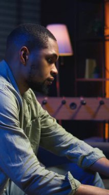 Dik Videolu Genç Yetişkin, kanepede oturup araştırma kağıtlarını analitikle okuyor, evdeki dosya ve belgelerle birden fazla iş yapıyor. İnsan profesyonel ya da kişisel gelişim konularına dalıyor