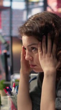 Dikey Video Günü tüccarı, mali kayıplara bakarak, bilgisayar üzerinden hisse senedi fiyat eğilimlerini analiz ederek endişeli ve stresli hissediyor. Öfkeli kadın hisselerini kaybediyor ve piyasa çöküşü ve ticaret kararlarıyla uğraşıyor.