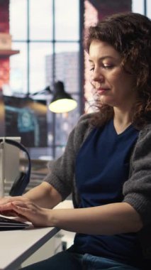 Geliştirme araçları ve bir terminal pencere arayüzü kullanılarak, izleme ve yazma satırları üzerinde çalışan dikey video bilişim uzmanı. Son teslim tarihinden önce kadın hata ayıklıyor. Kamera.