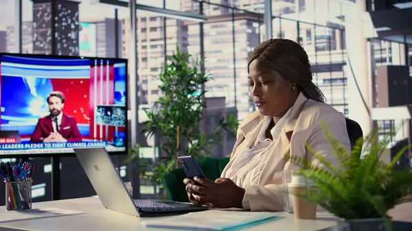 Afrikalı Amerikalı CEO ekibiyle güncellemeler ya da iş fikirleri hakkında mesajlar atıyor, internet bağlantısı hakkında proje içgörüsünü paylaşıyor. Başarılı hedef odaklı yönetmen. Kamera B.