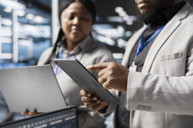 Veri Merkezi çalışanları sunucu teknolojisini güncellemek ve altyapıyı yapılandırmak için birlikte çalışıyorlar. Sunucu merkezi bilişim uzmanları beyin fırtınası yapıyor, donanım analizlerini inceliyor, kapatıyorlar.