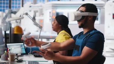 Güneş panellerindeki Afrikalı Amerikalı teknisyenler VR gözlük kullanarak tesis kuruyor CAD yazılımı kullanarak yerleşimleri optimize ediyorlar. Fotovoltaik fabrika işçisi sanal gerçeklik teknolojisini kullanarak düzenlemeler yapıyor. Kamera A.