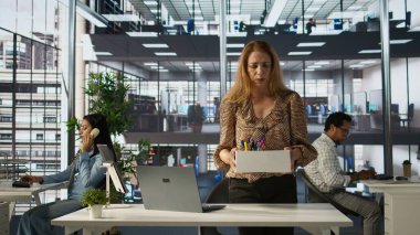 İşkadını kovulduktan sonra ofis eşyalarını bir kutuda topluyor, işsizlik konusunda sinirli ve stresli hissediyor. İşsiz biri iş yerinden ayrılıyor, iş bulamıyor. Kamera B.