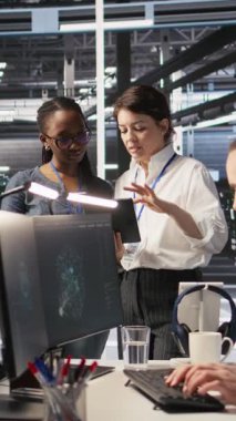 Dikey video veri merkezi takım arkadaşları sunucu raflarında yapay zeka işleme için bakım yapıyorlar. Makine için kullanılan sunucu merkezi donanımlarını yöneten mühendislik ekibi