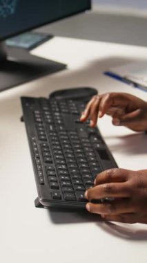 PC 'deki veri merkezi yönetici kodlamasının dikey videosu, yapay zeka ana bilgisayarları için yazılım güncellemeleri yapıyor. Bilgisayar klavyesinde yazan sunucu çiftliği bilişim uzmanı, altyapının optimizasyonu, kamera A