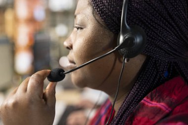 Telsiz mikrofonunu kullanarak teknik soruşturmalara cevap vererek donanım sorunları ile ilgili sorulara yardımcı olan çağrı merkezi ajanı. Müşteri hizmetlerinde çalışan kadın, sorun giderme sorunları, kapatın.