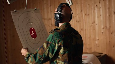 Pozitif sonuç elde ettikten sonra, neşeli ordu birliği atış menzilindeki hedefleri tabancayla vuruyor. Heyecanlı asker eğitimi. Hedef tahtası, kamera A 'yı vurduktan sonra heyecanlandı.