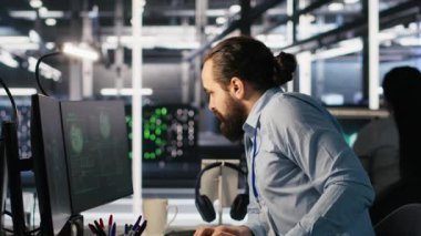 Veri merkezindeki kaygılı teknisyenler fidye yazılımının neden olduğu kilitlenmeye tepki veriyorlar. Güvenlik ihlallerini değerlendiren ve hasarı kontrol altına almak için çabalayan bilişim uzmanları, kamera A