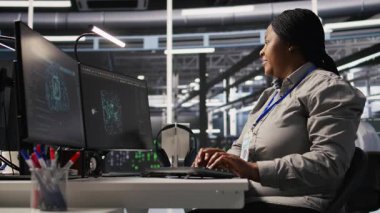 Veri Merkezi bilgisayar bilimcisi PC 'yi kullanarak yapay zeka görselleştirmesini izliyor. Sunucu çiftliği bilişim uzmanı donanımları denetliyor makine öğrenme süreçleri, kamera A