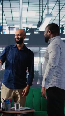 Bir müzakere toplantısında birbirlerine hoş geldin diyen çok kültürlü CEO 'lardan oluşan dikey video grubu, uluslararası şirketleri arasında yeni ve başarılı bir ortaklığın detaylarını tartışıyor.