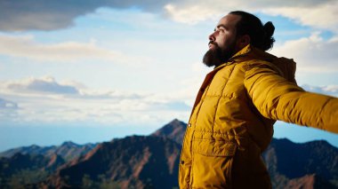 Huzurlu bir kâşif, stres atmak için meditasyon yapıyor. Dağın tepesinde rahatlık ve denge için dinleniyor. Genç gezgin, farkındalık için meditasyon yapıyor. Kamera A.