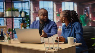 Afrikalı kızgın insanlar internet sorunlarıyla mücadele ediyorlar, LAN kablolarını test ediyorlar ve Wi-Fi ayarlarını bağlantıyı geri getirmek için ayarlıyorlar. Hayal kırıklığına uğramış serbest çalışanlar. Kamera A.