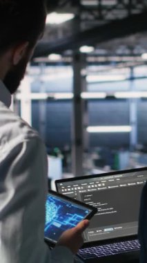 Dikey video sunucusu çiftlik yöneticisi, altyapı yapay zeka öğrenme otomatikleştirmesi yapan işçileri denetliyor. Veri Merkezi ekip lideri yapay zeka kullanan çalışanları denetliyor, kamera B