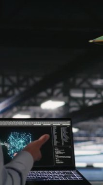 Yüksek teknoloji sunucu tesisinde yapay zeka işlemlerini yöneten dikey video askeri personel. Ordu teknoloji uzmanları iletişim sistemlerini denetlemek için yapay zeka kullanıyor, kamera B