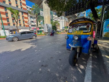 Bangkok, Tayland - 11 Kasım 2024: Turistlerin gezmek için şehirde taşımacılık yaptığı tropikal tuk aracı. Ana caddelerde yerel bir taksiyle egzotik eğlence aktivitesi.