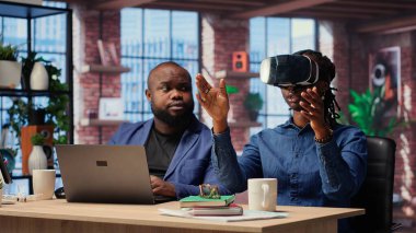 Serbest çalışan çift, gelişmiş teknolojiyle uzaktan kumandalı bir işte çalışıyor. Genç adam, VR kulaklığıyla 3 boyutlu simülasyonları keşfediyor. Yapay zeka, metaevren ve modern kariyerlerde yenilik. Kamera B.