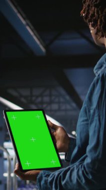 Dikey Veri Merkezi mühendisleri yeşil ekran tableti kullanarak sinirsel ağ LLM görselleştirmesini izliyorlar. Sunucu çiftliği bilişim uzmanları krom anahtar kullanarak güç makinelerinin öğrenme süreçlerini denetliyor