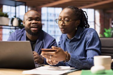 Sorumlu erkek ve kadın faturaları ödüyor ve vergilerini dizüstü bilgisayarla ödüyor, ödeme detaylarını internete giriyor ve para transferini onaylıyor. Çevrimiçi bankacılık ve evde finans yönetimi.