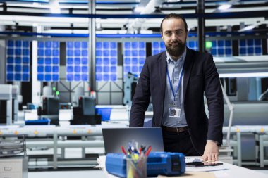 Endüstriyel danışman yüksek teknolojili güneş enerjisi üretim hattını inceleyerek, temiz enerji geliştirme, yenilenebilir sistem tasarımı ve akıllı altyapı planlama kavramlarını gözden geçirir..