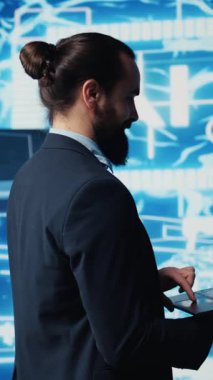 Dikey Video Genç girişimcisi öngörücü analitik ve makine öğrenme algoritmalarını inceliyor. Dijital arayüz yenilik, kodlama, yapay zeka etiği ve platformların dönüşümünü yansıtır. Kamera B.