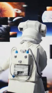 Yıldızlarla ve galaksiyle çevrili kozmik bir yolculukta olan dikey video uzay adamı gerçeküstü keşifler sergiliyor. Kostümlü ve kasklı erkek astronot evrende, dış uzayda seyahat ediyor.