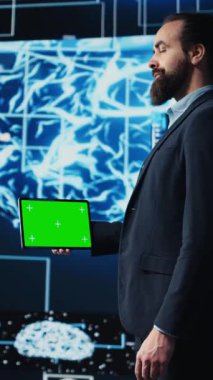 Modern yapay zeka beyin animasyonuyla çevrili dikey video, girişimci cihaz üzerindeki yeşil ekranla sanal zekayı keşfediyor. Yeni bir yenilikçi bilişim stratejisi için otomasyon platformlarını kullanmak. Kamera B.