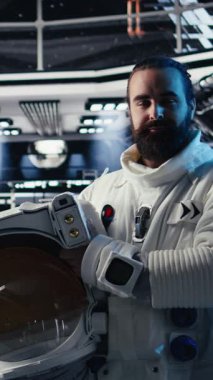 Fütürist uzay gemisinin içindeki dikey video astronot rutin görev kontrolü sırasında Kızıl Gezegen yolculuk analizlerini kontrol ediyor. Uzay istasyonu kozmonotu Mars 'ı gösteren monitörün yanında duran aygıtı kullanıyor.