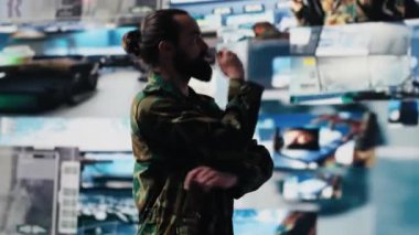 Erkek ordu subayı, dijital teknolojisi olan bir komuta merkezinden modern savaş stratejisi için uydu istihbaratını izliyor. Aktif operasyonlarda güvenli iletişim. Kamera A.