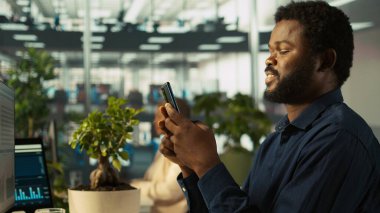 Ofisteki çalışan, akıllı telefon kullanarak dokümanları kontrol etmekten, arkadaşlarına mesaj göndermeye ara veriyor, dinleniyor. Ofisteki muhasebeci cep telefonundaki ve kamera B 'deki mesajlara cevap vermek için görevleri durduruyor