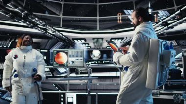 Gelişmiş teknoloji uzay aracındaki astronot ekibi rutin görev kontrolü sırasında Kırmızı Gezegen Özet Analizlerini kontrol ediyor. Takım çalışması Yörünge İstasyonu mürettebatı Mars verilerine bakmak için aygıt kullanıyor