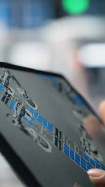 Vertical Video Solar power technician reviewing data on tablet in photovoltaics factory, inspecting manufacturing plant performance and production line for solar innovation. Alternative energy. Camera