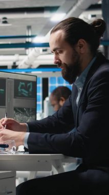 Vertical Video Professional Mühendisi güneş panelleri tesisinde bilgisayar görüşünü inceleyerek, üretim hattı ve kalkınma hedefleri için alternatif enerji sistemlerini güvence altına almak için bir teftiş yürütüyor. Kamera.