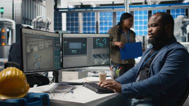 Sanayi uzmanı, güneş paneli fabrikası kurarak, temiz sürdürülebilir enerji üzerinde çalışarak, birleştirme işlemini bilgisayarda yürütüyor. Üretim akışı için mühendislik yeniliği. Kamera A.