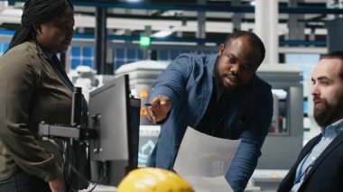 Fabrikadaki çeşitli iş arkadaşları güneş enerjisi üretim hattını işleyerek fotovoltaik üretim sistemlerinde takım çalışması gösteriyorlar. Fabrikada temiz alternatif enerji yönetimi. Kamera A.