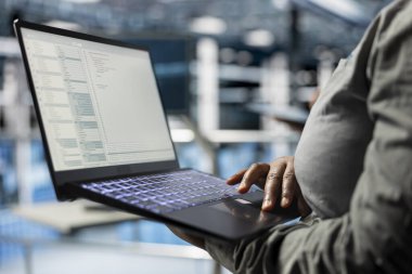 Close up of laptop used by data center software developer to upgrade system stability. Server hub IT professional coding, optimizing performance with device, configuring gear