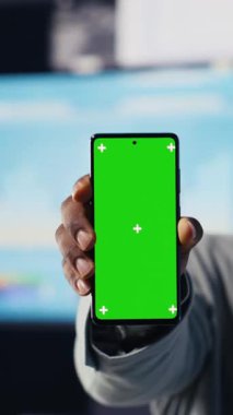 Dikey Video Afrikalı Amerikalı yönetici telefondaki kopyalama alanını kullanır ve gösterge panellerini inceler, KPI projeksiyonları ile analitik ve performans ölçümleri sağlar. Yenilik için yönetim kararı