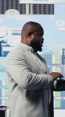 Vertical Video Business uzmanı finansal modeller ve projeksiyonlarla dijital gösterge panelini inceliyor, cihaz üzerinde bilgi grafikleriyle stratejik planlama üzerinde çalışıyor. Kurumsal ekonomi yönetimi ve analizi